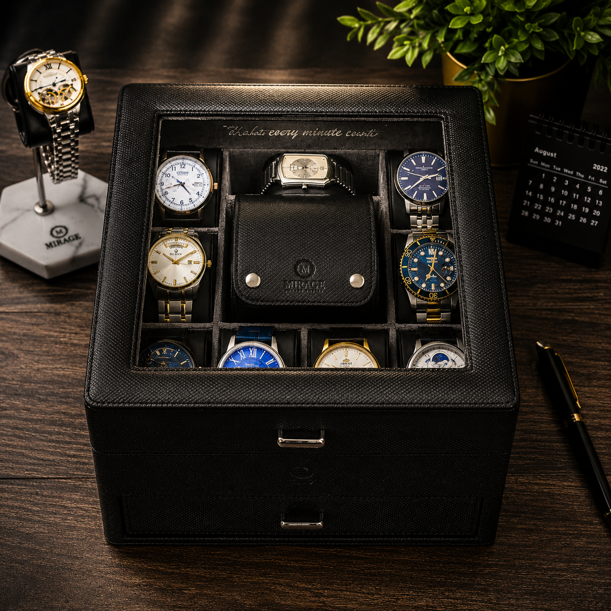 A black textured watch storage box with a glass top displaying multiple watches arranged in compartments. The box has a hinged lid and a drawstring closure.