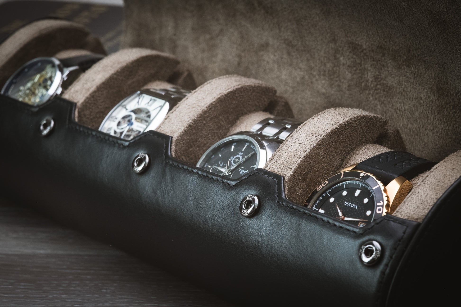 Close-up of luxury watches securely stored inside the Mirage full-grain leather watch roll with suede interior.