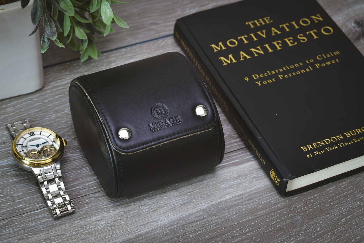Closed Sable Black full-grain cow leather 1 watch roll displayed beside a luxury watch and book, showcasing premium watch storage and travel protection.