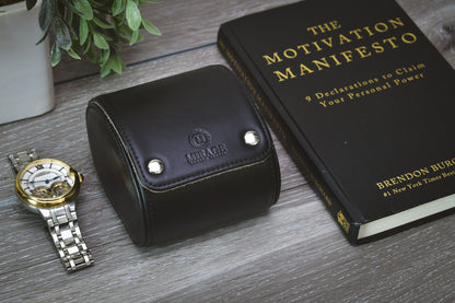 Closed Sable Black full-grain cow leather 1 watch roll displayed beside a luxury watch and book, showcasing premium watch storage and travel protection.