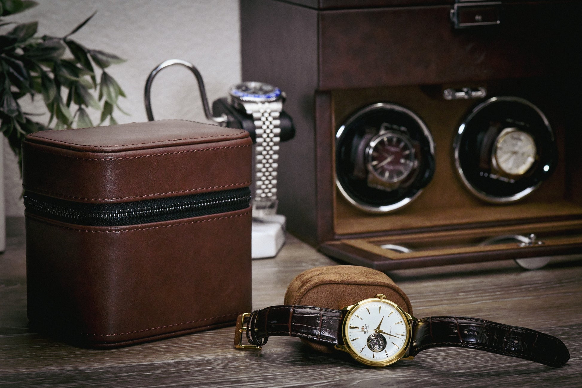 Coffee Brown genuine leather watch and jewelry travel case displayed with luxury watches in an elegant home setting, showcasing premium suede-lined protection.