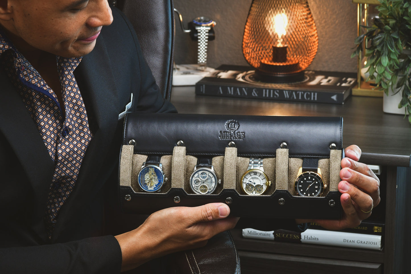 Watch collector holding the Mirage Luxury Travel sable black leather watch roll with luxury watches displayed.