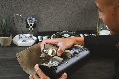 Watch collector organizing luxury watches inside the Mirage Luxury Travel sable black watch roll.