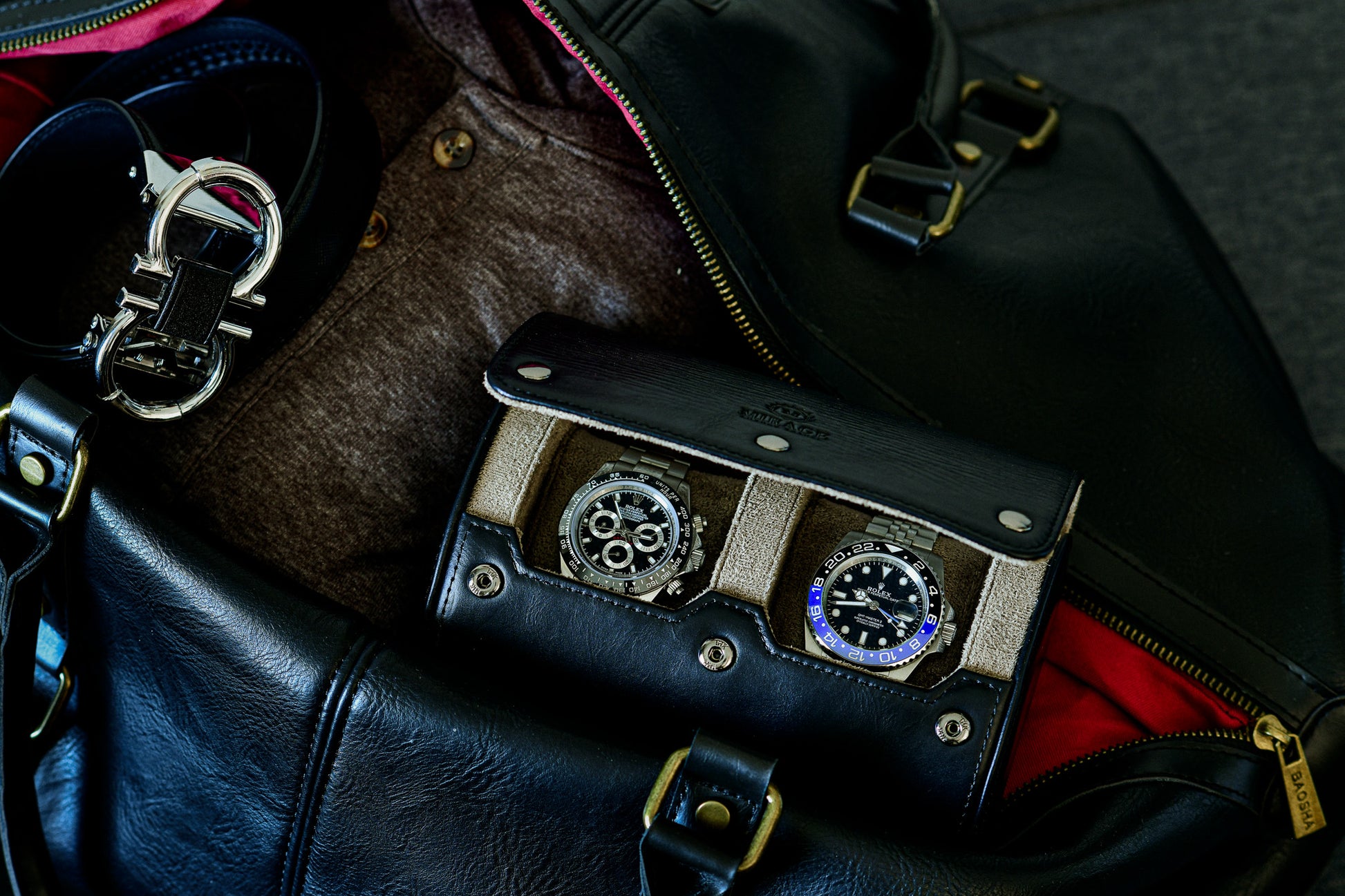 Luxury watches stored inside the Sable Black 2 watch roll with travel accessories.