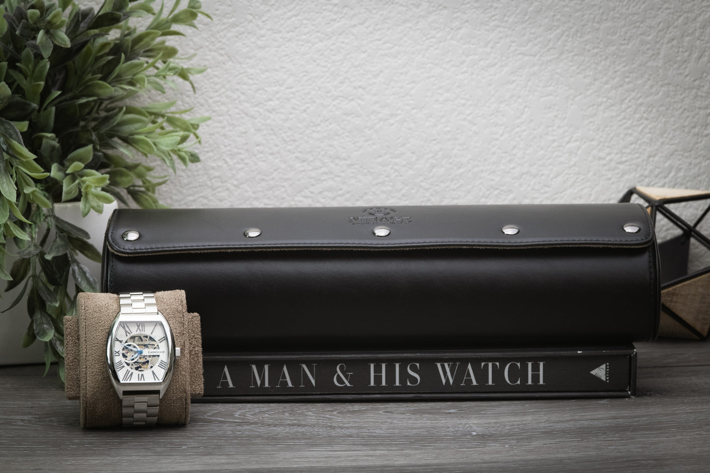 Sable black full-grain leather watch roll displayed beside a luxury watch for home organization.