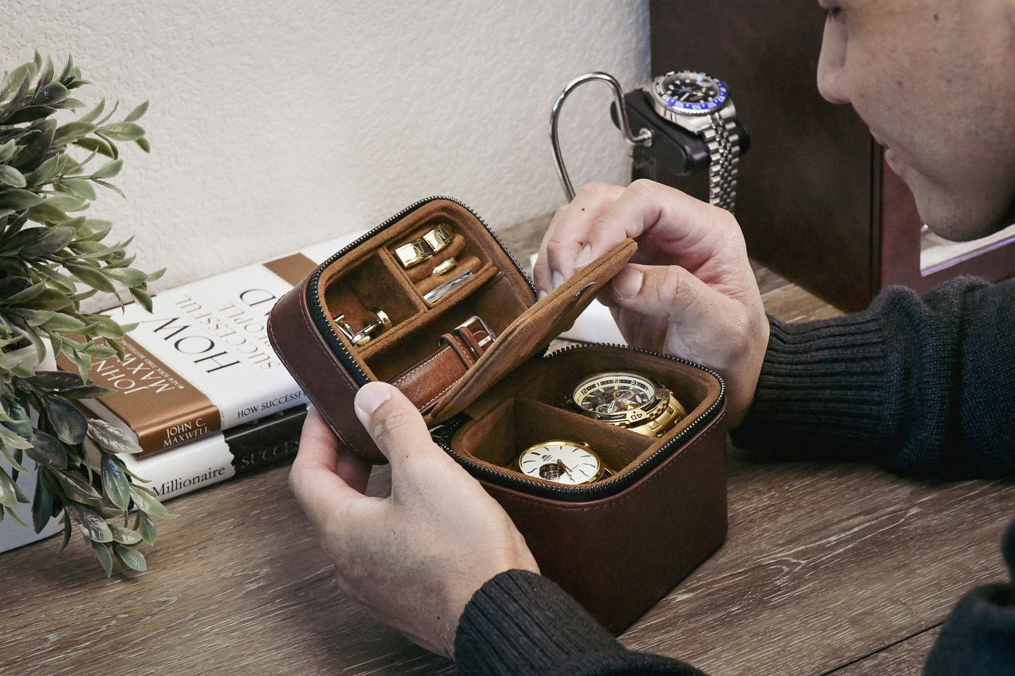 Hands opening the Coffee Brown genuine leather watch and jewelry travel case, showcasing organized storage for watches and jewelry.