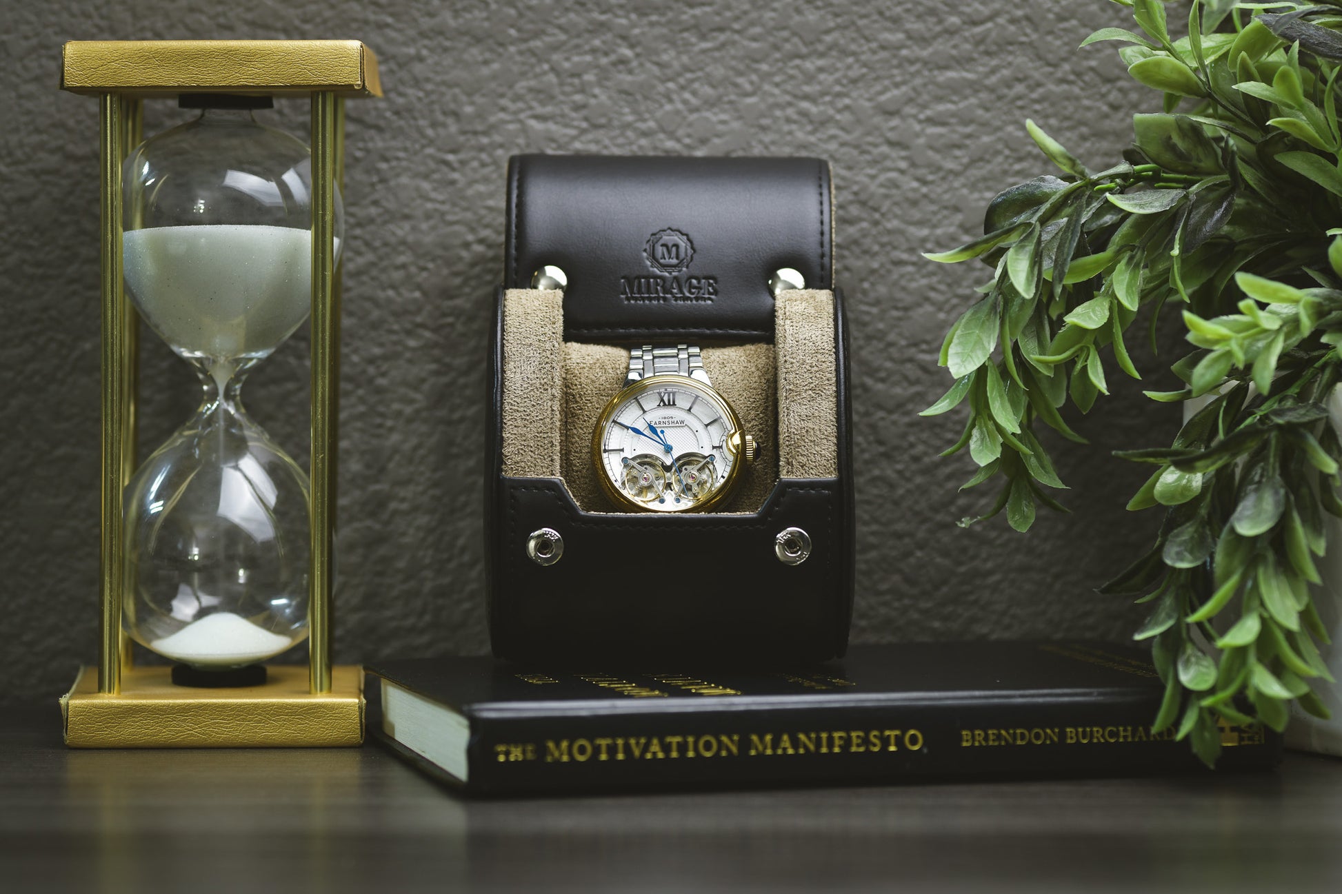 Sable Black full-grain cow leather 1 watch roll displayed with the Mirage Luxury Travel gift box, luxury watch, hourglass, and plant for an elegant collector presentation.
