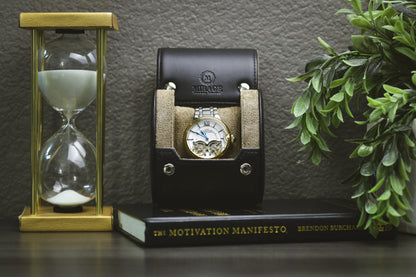 Sable Black full-grain cow leather 1 watch roll displayed with the Mirage Luxury Travel gift box, luxury watch, hourglass, and plant for an elegant collector presentation.