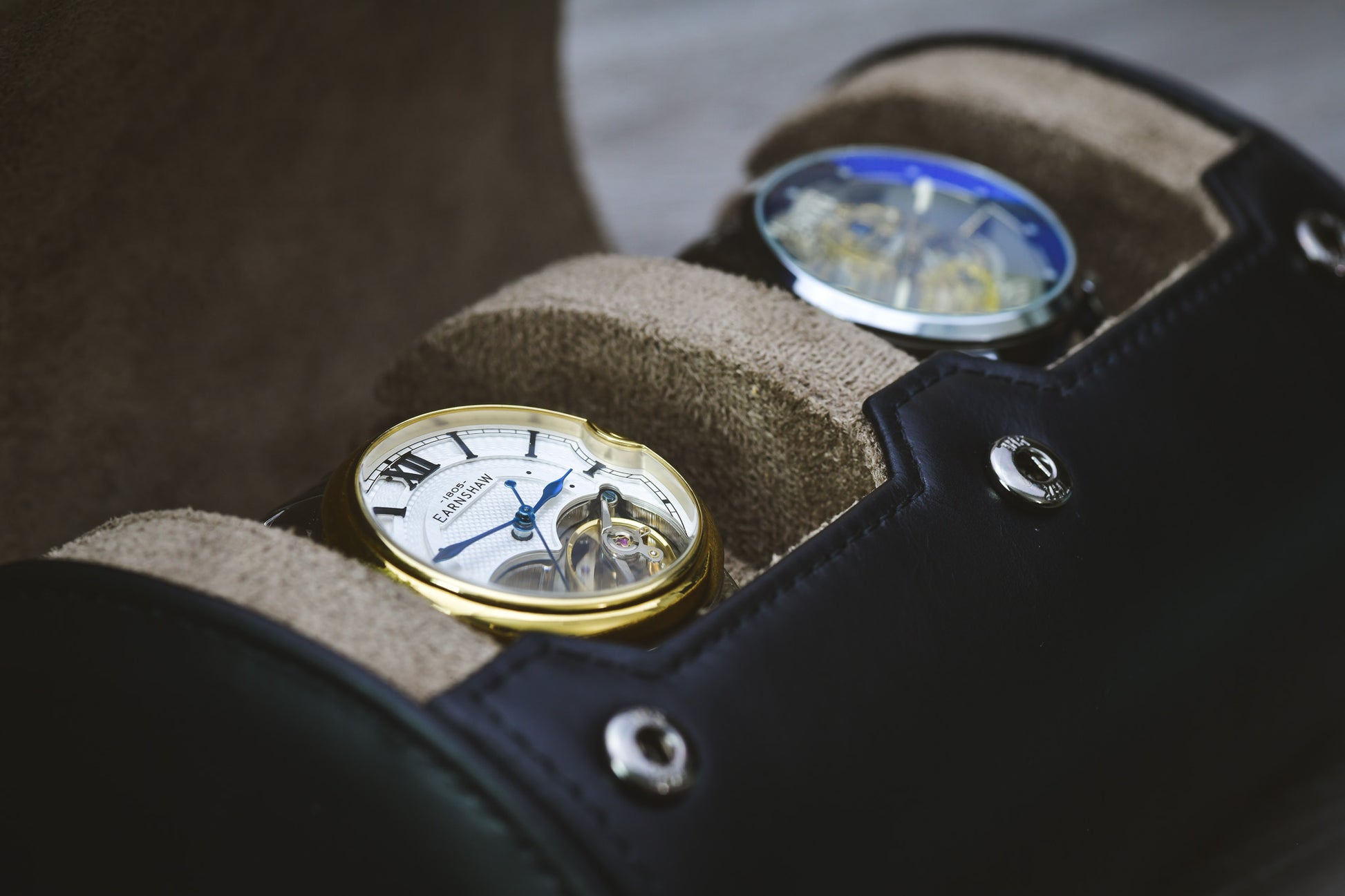 Close-Up
Close-up of two luxury watches secured inside the Sable Black full-grain cow leather watch roll.