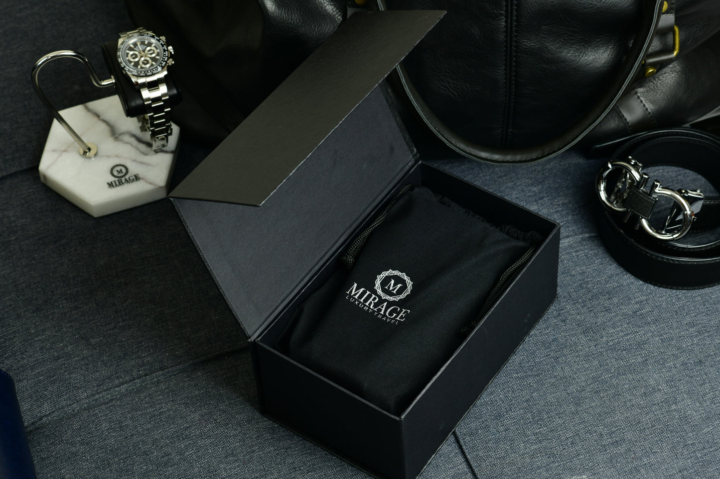 Close-up of the embossed Mirage Luxury Travel logo on Sable Black full-grain cow leather.