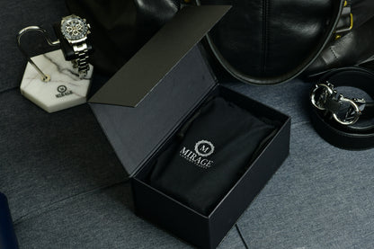Close-up of the embossed Mirage Luxury Travel logo on Sable Black full-grain cow leather.