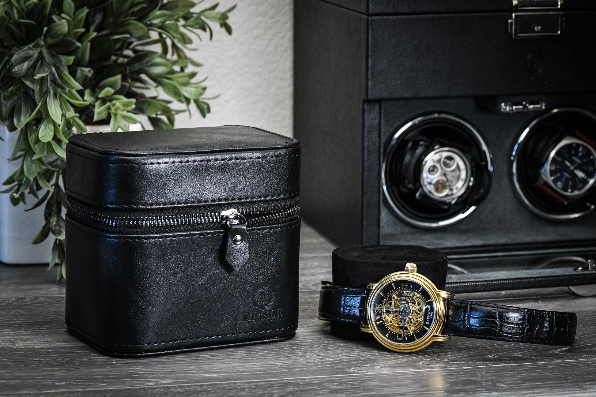 Obsedian Black genuine leather watch and jewelry travel case displayed with luxury watches, showcasing premium suede-lined protection and elegant organization.