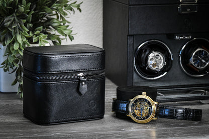 Obsedian Black genuine leather watch and jewelry travel case displayed with luxury watches, showcasing premium suede-lined protection and elegant organization.