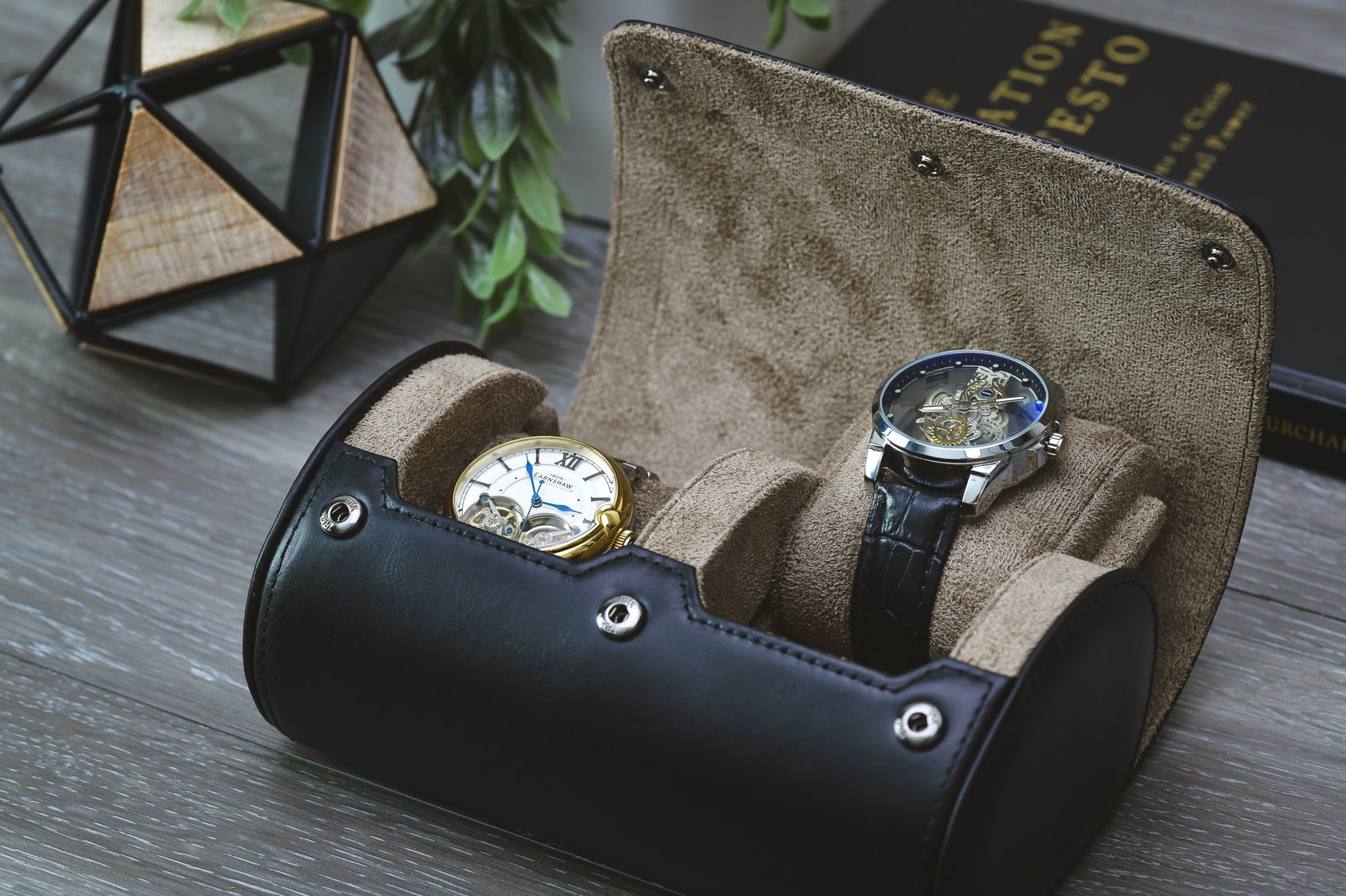 Sable Black full-grain cow leather 2 watch roll displayed open with two luxury watches in a modern home setting.