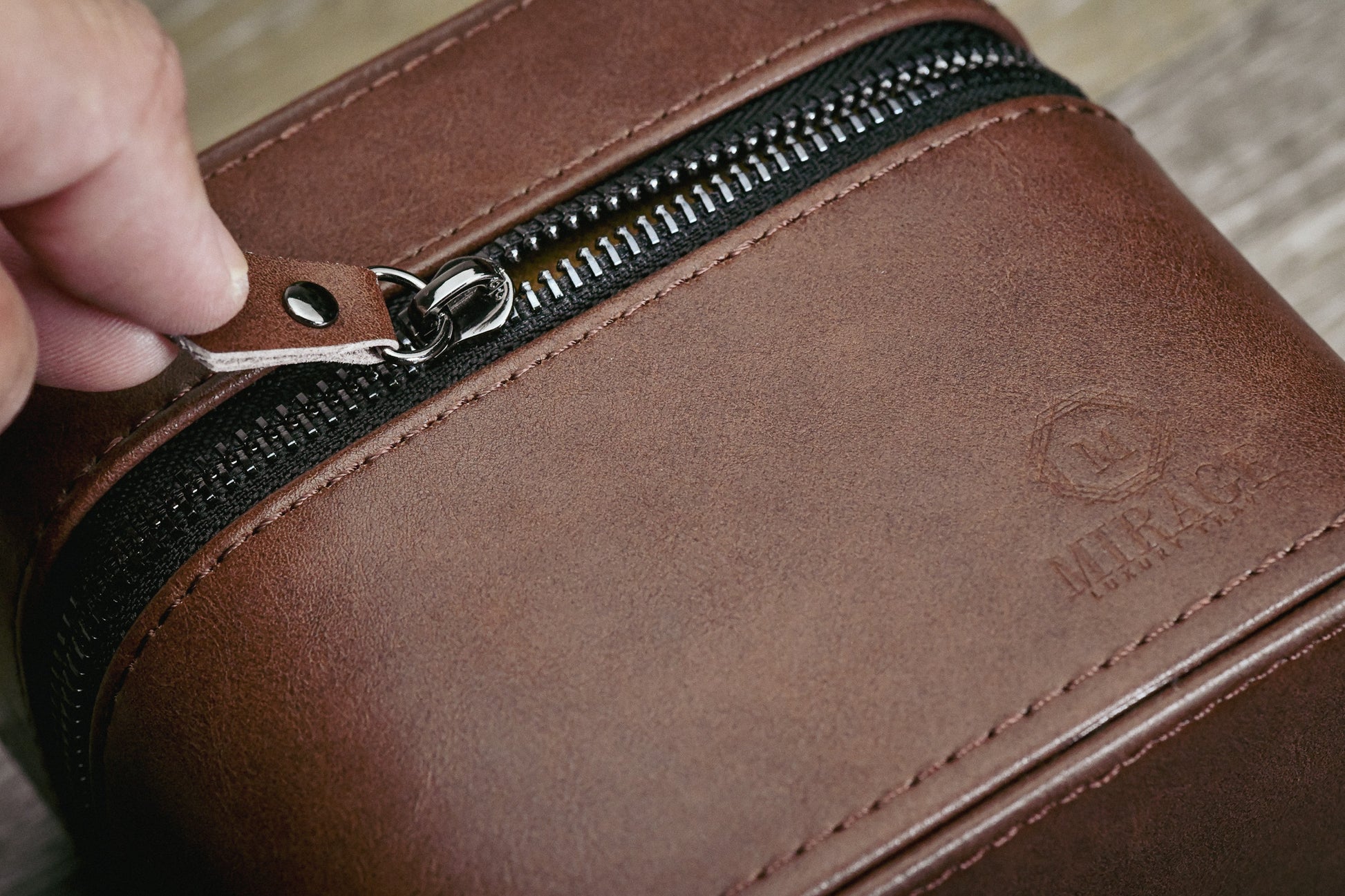 Close-up of the Coffee Brown genuine leather watch and jewelry travel case highlighting premium leather craftsmanship and durable zipper closure.