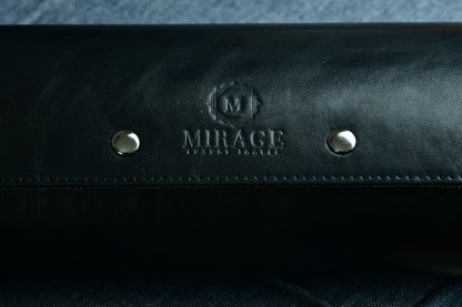 Close-up of the Mirage logo embossed on premium sable black Saffiano leather.