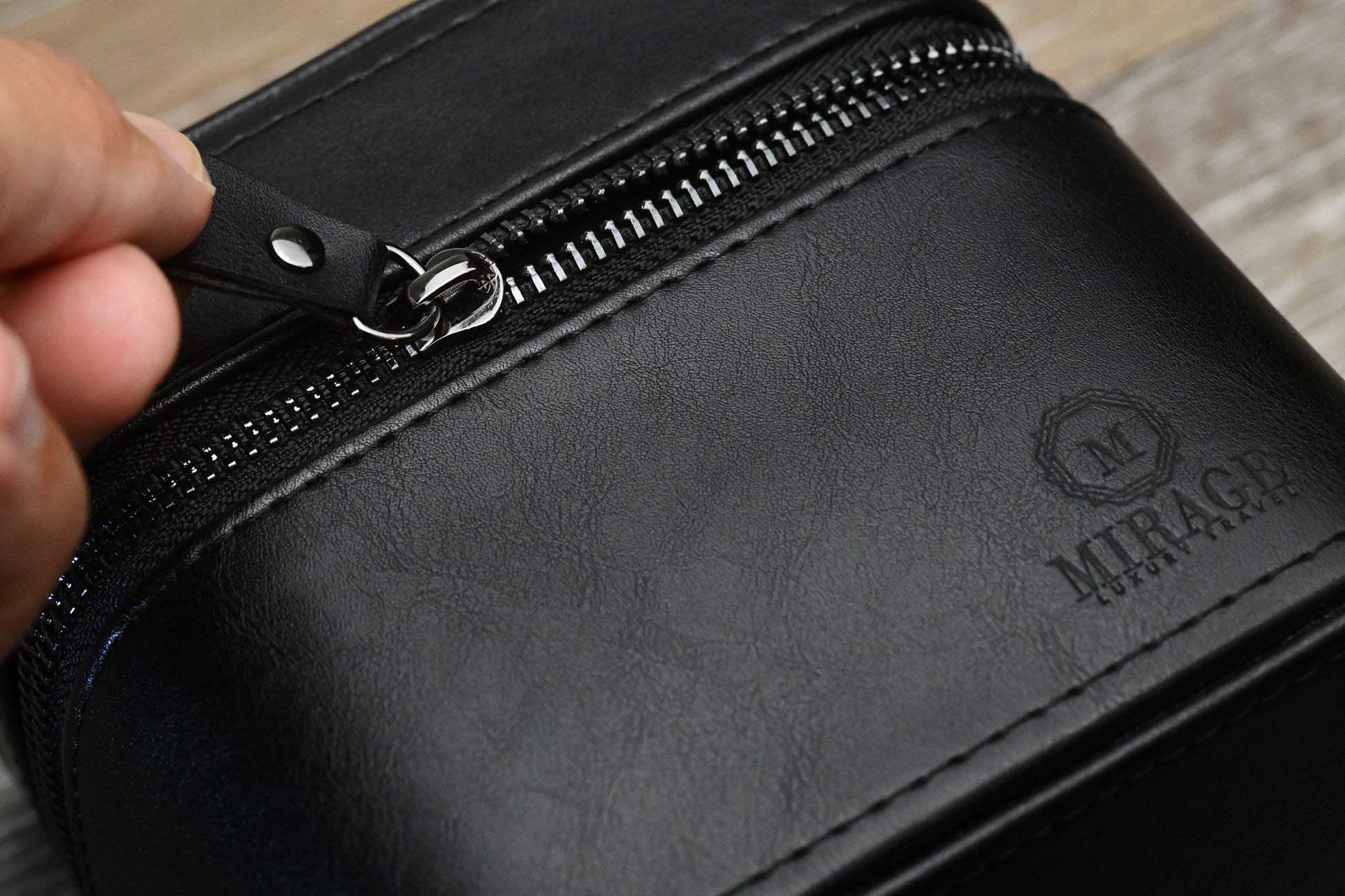 Close-up of the Obsedian Black genuine leather watch and jewelry travel case highlighting premium leather craftsmanship and durable zipper closure.