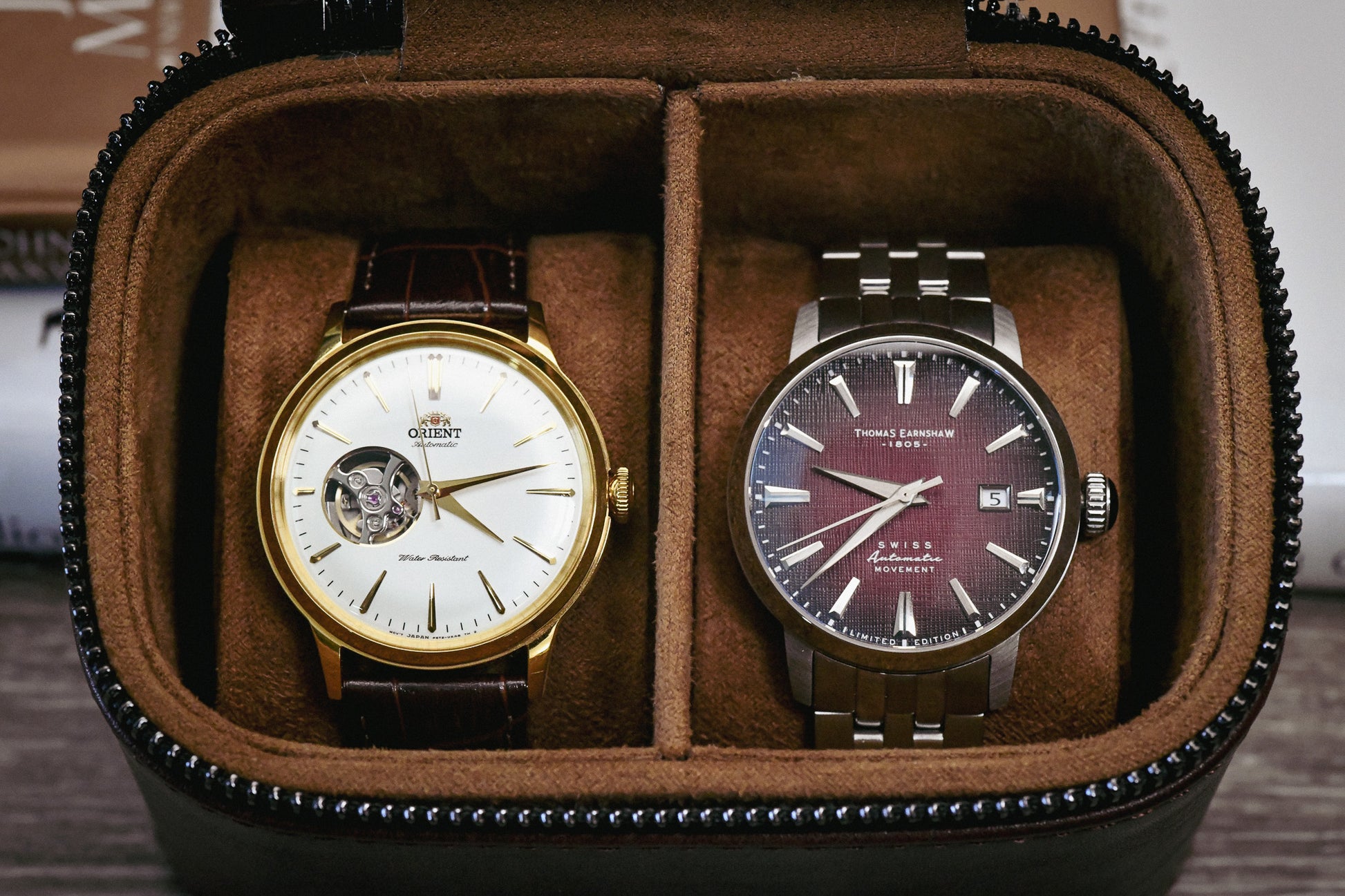 Premium suede-lined interior of the Coffee Brown genuine leather watch and jewelry travel case securely holding two luxury watches.