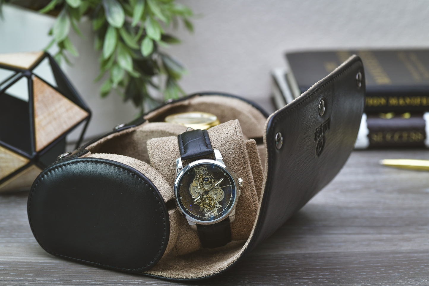 Side view of the rolled Sable Black full-grain cow leather watch roll highlighting its compact travel design.
