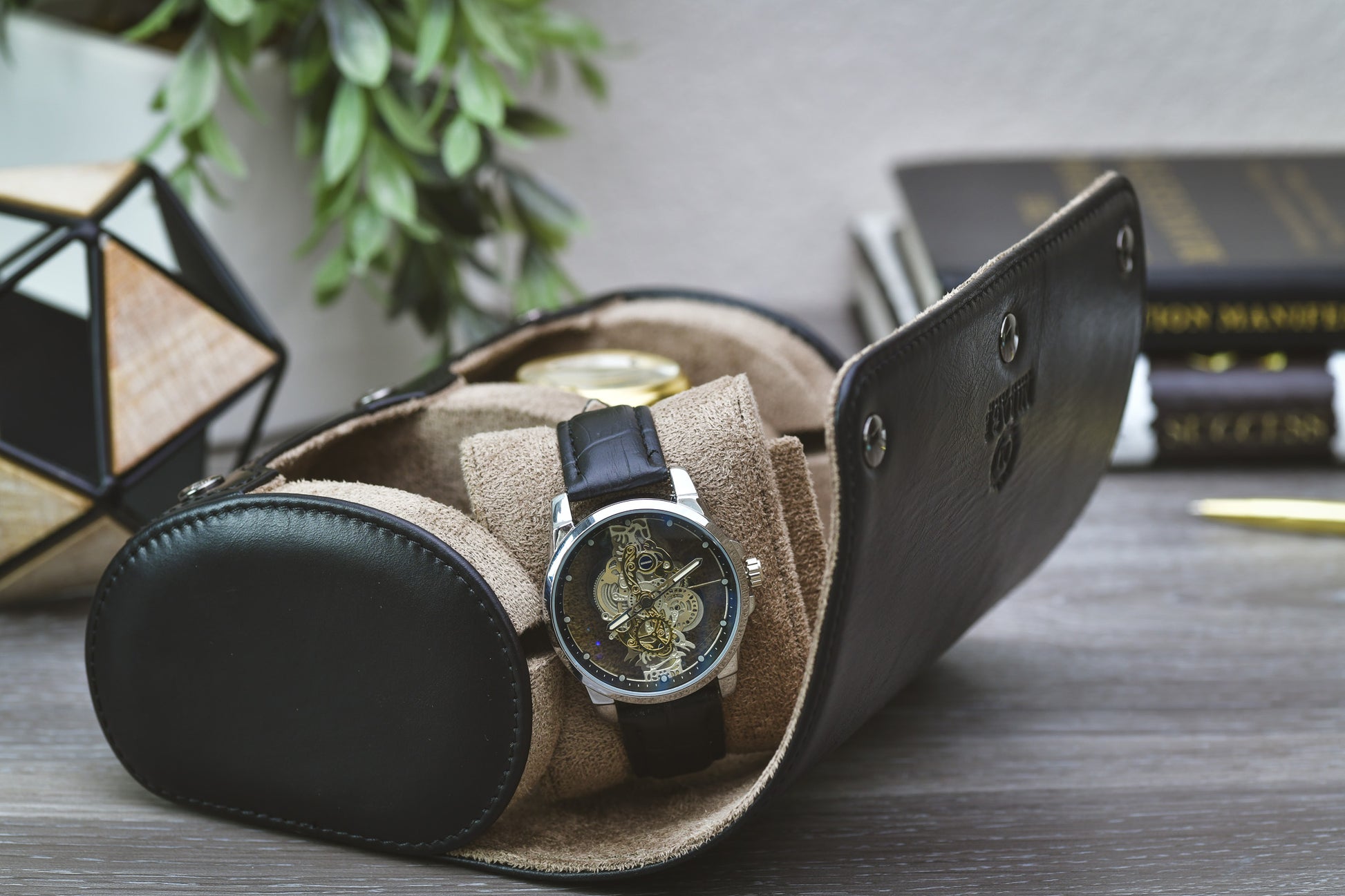 Side view of the rolled Sable Black full-grain cow leather watch roll highlighting its compact travel design.