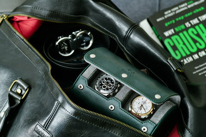 Royal Green vegan leather 2 watch travel case stored inside a leather duffel bag for business travel and luxury watch protection.