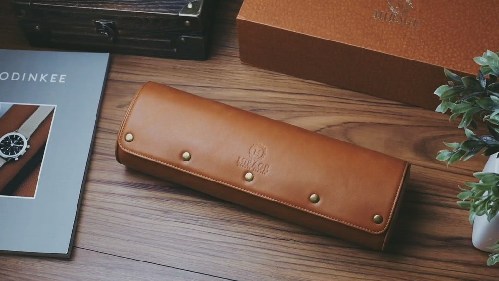 Closed Tawny Brown full-grain leather 4 watch roll with secure snap closure and embossed Mirage logo.
