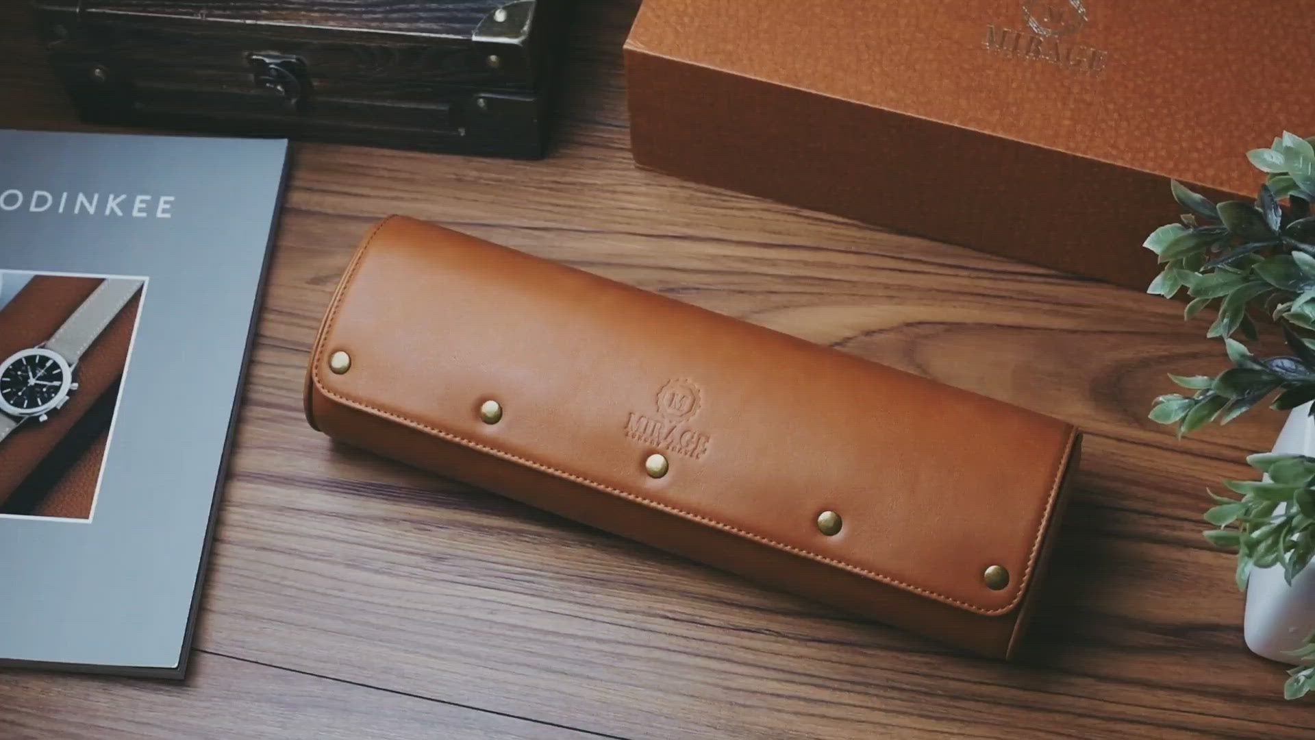 Closed Tawny Brown full-grain leather 4 watch roll with secure snap closure and embossed Mirage logo.
