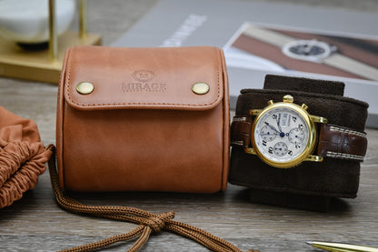 Closed Tawny Brown full-grain cow leather 1 watch roll displayed beside a luxury watch, emphasizing compact travel-ready protection.