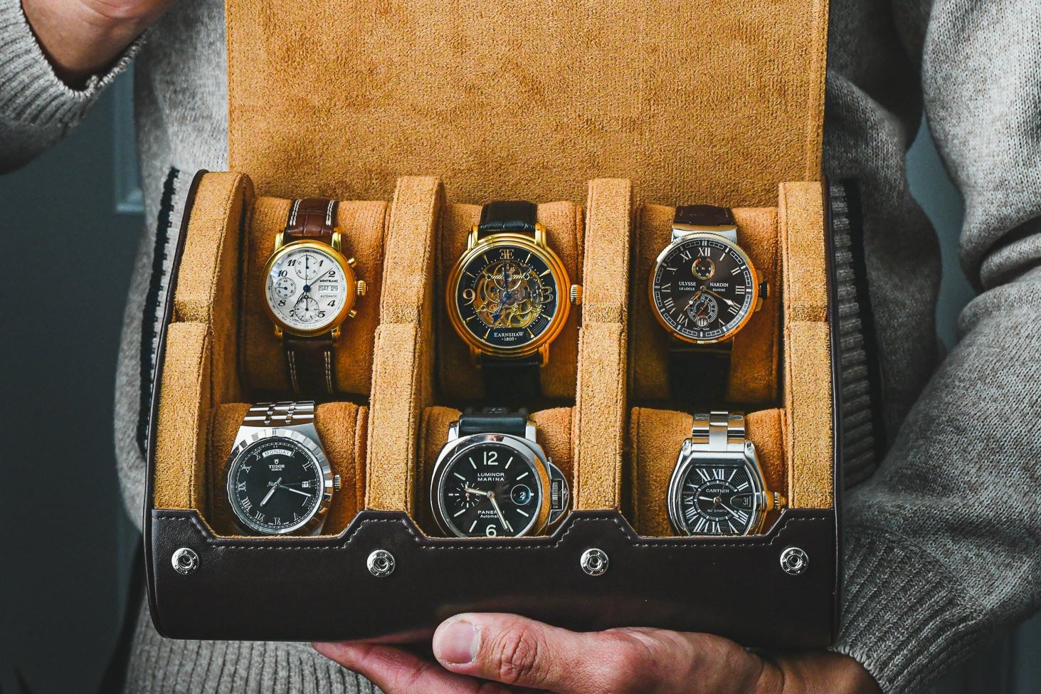 Collector showing his collections of watches safely secured in this 6 watch roll espresso brown