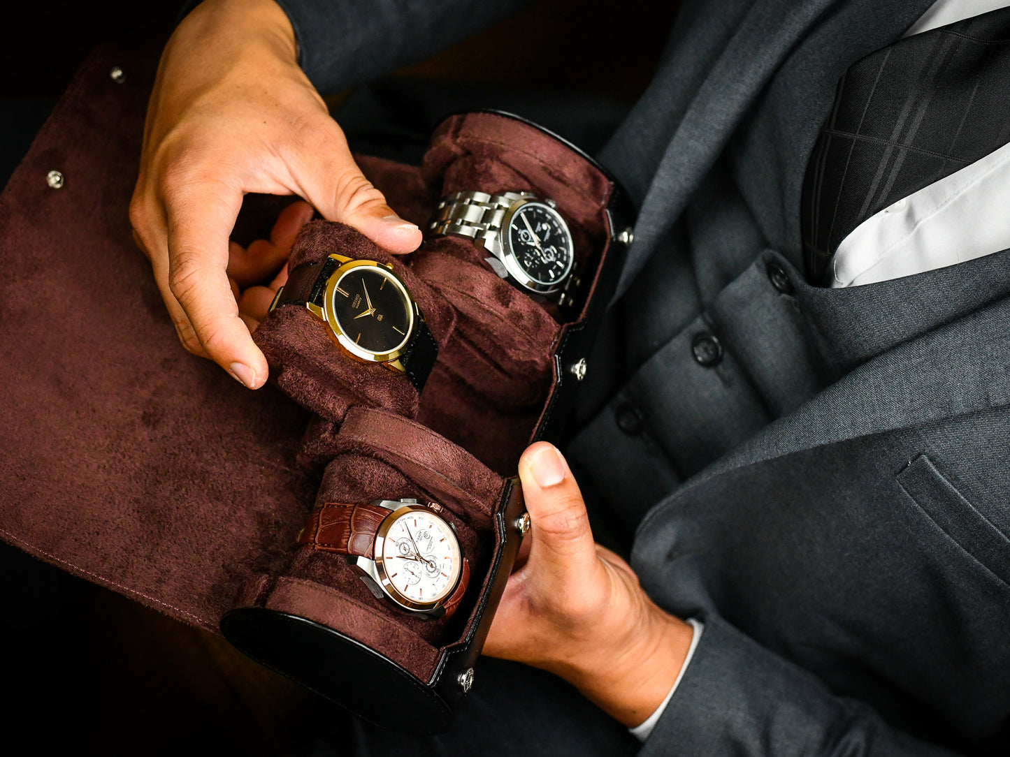 Watch collector placing luxury watches into Jade Black premium vegan leather 3 watch travel case