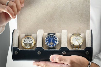 Watch collector holding Midnight Blue 3 watch travel case with ivory white interior and luxury watches