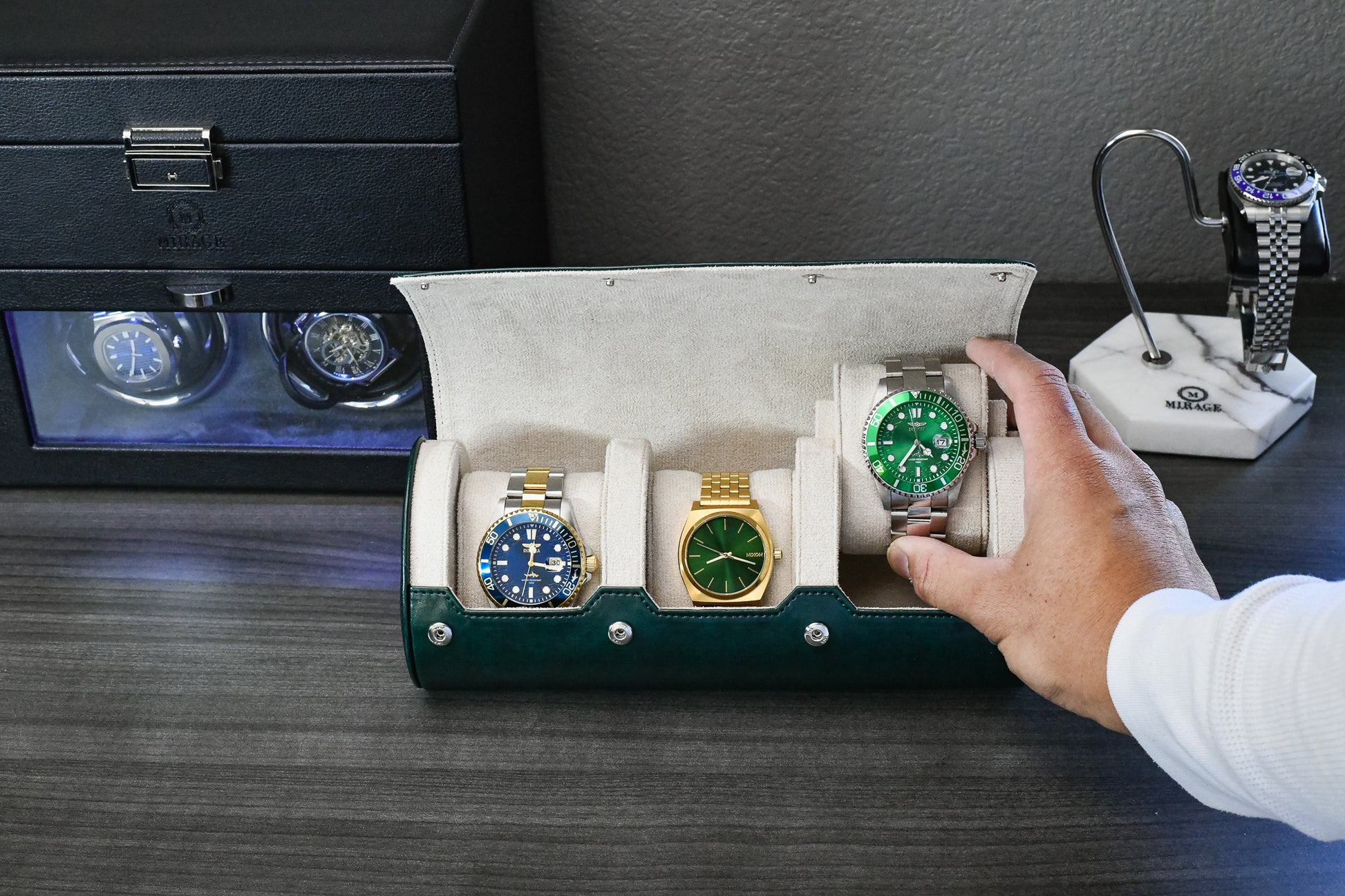 Watch collector placing luxury watches into Royal Green 3 watch travel case with ivory white interior