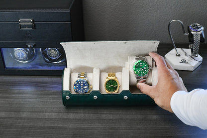Watch collector placing luxury watches into Royal Green 3 watch travel case with ivory white interior