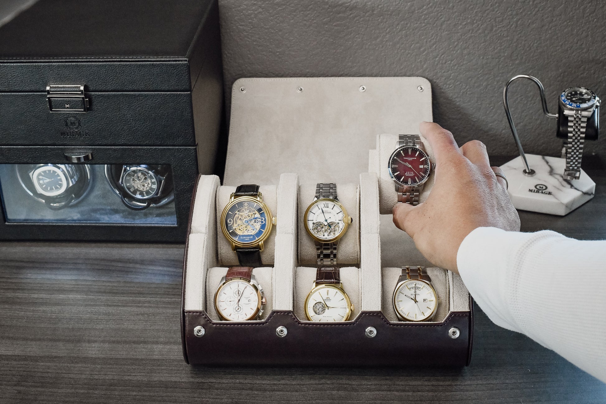 Collector securing his watch that secured in suede lined pillow inside Espresso Brown 6 watch travel case.