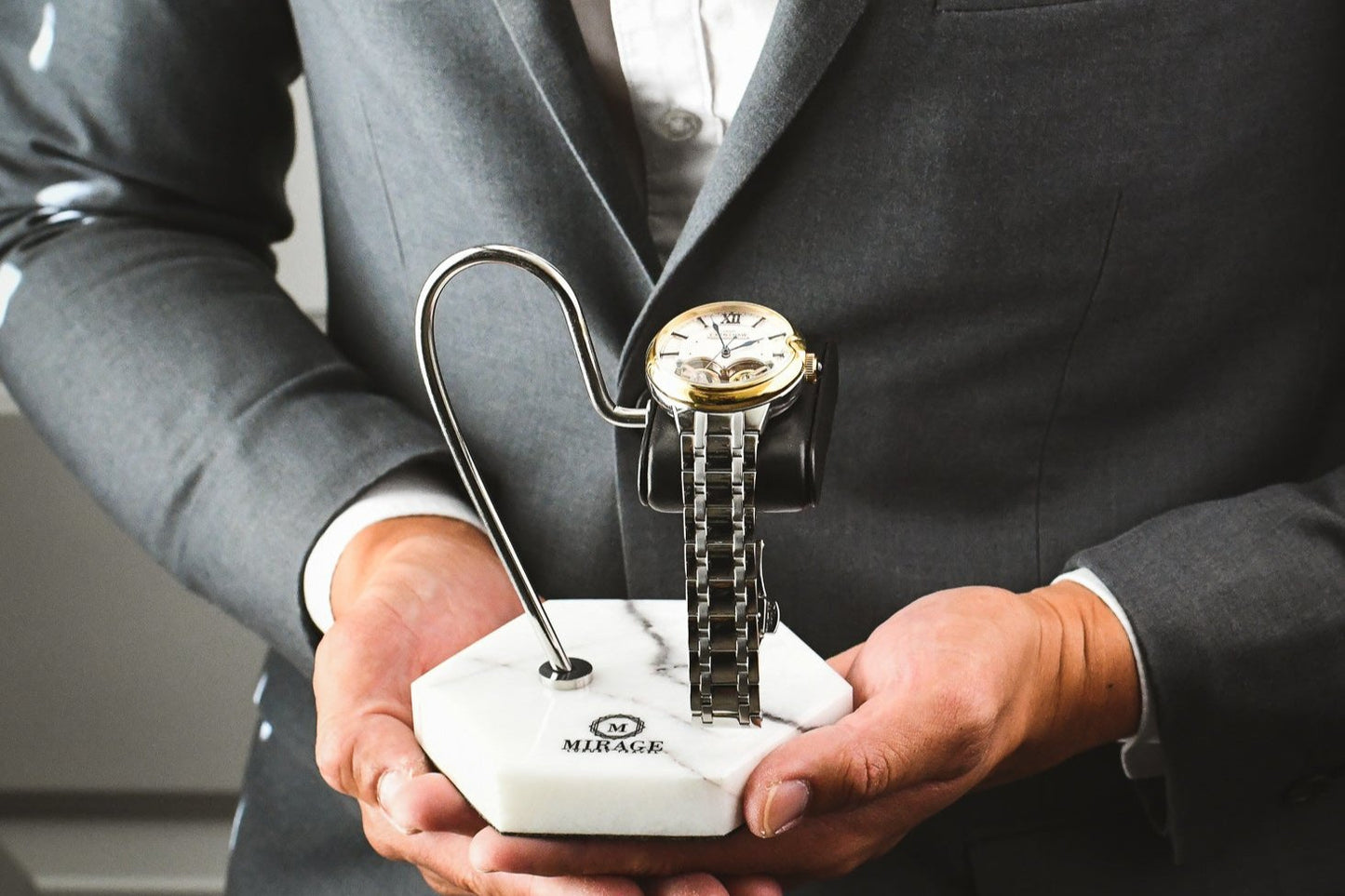 Mirage Luxury Travel Elite White Lilac Marble watch stand with genuine black leather cushion displayed in hand, showcasing an elegant luxury watch display for collectors.