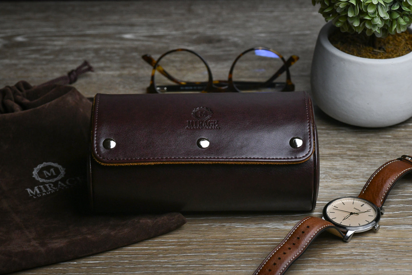 Closed Espresso Brown vegan leather 2 watch roll displayed with sunglasses and luxury accessories.