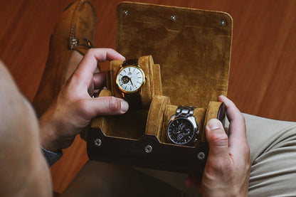 Collector placing luxury watches into the Espresso Brown vegan leather 2 watch roll.