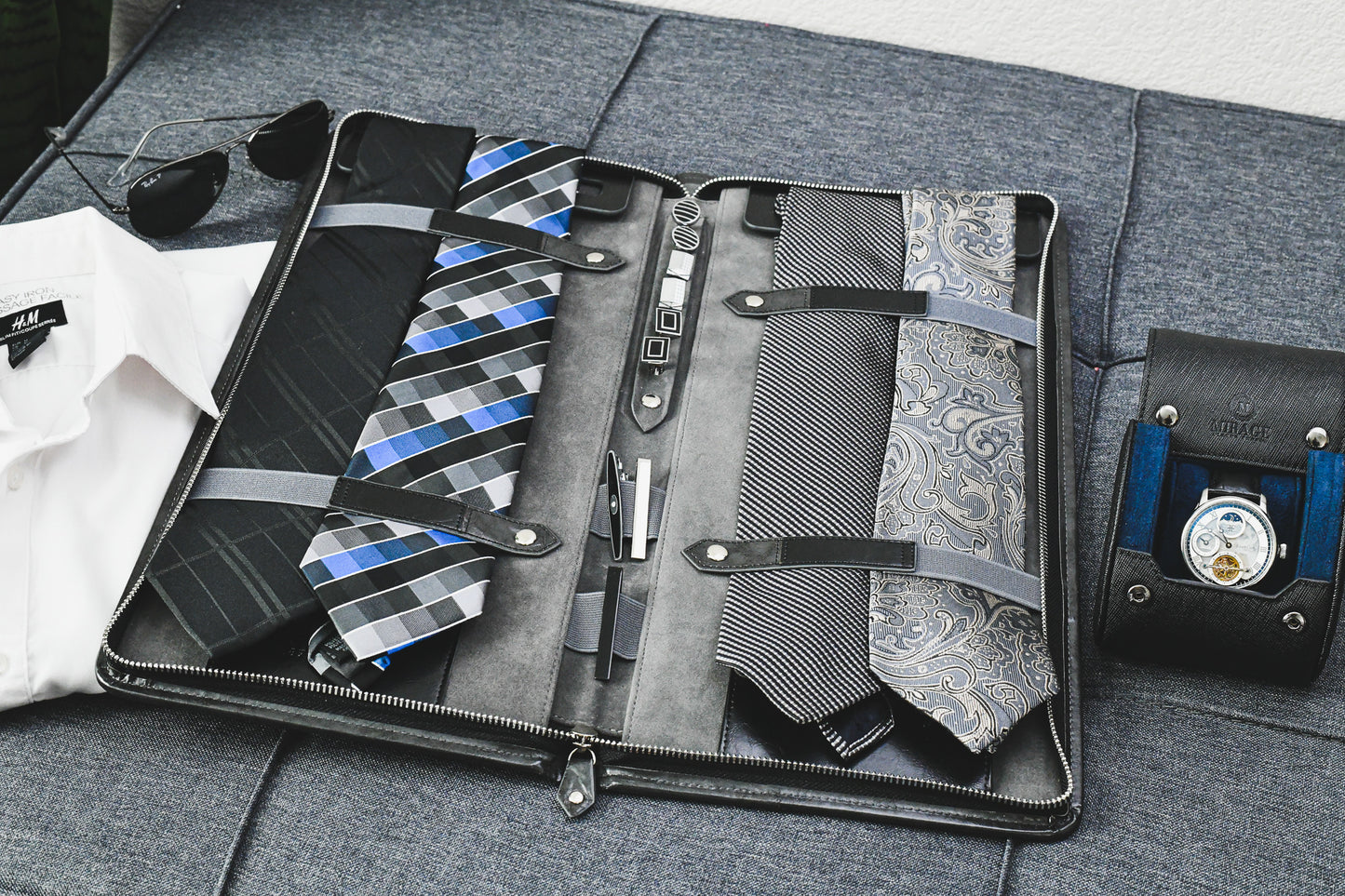 Open Graphite Black premium vegan leather tie travel case with organized ties, cufflinks, tie clips, and collar stays for business travel.
