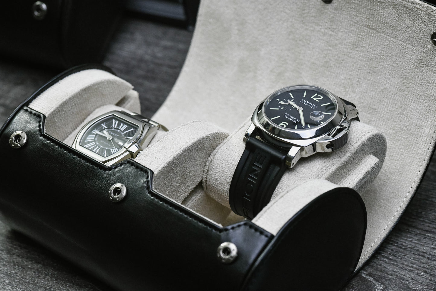 Close-up of luxury watches resting inside the Jade Black vegan leather 2 watch organizer with soft ivory white suede lining.