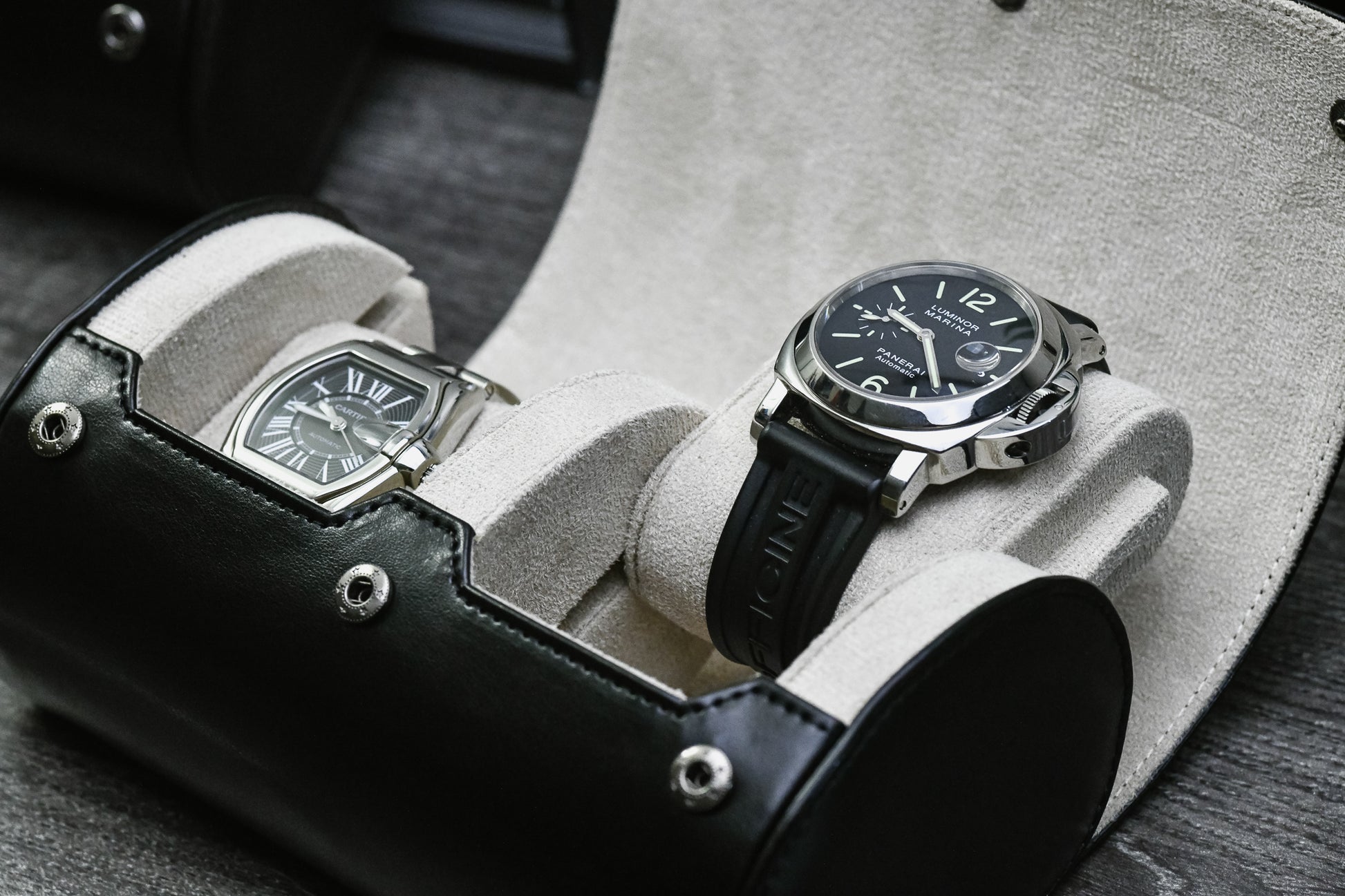 Close-up of luxury watches resting inside the Jade Black vegan leather 2 watch organizer with soft ivory white suede lining.