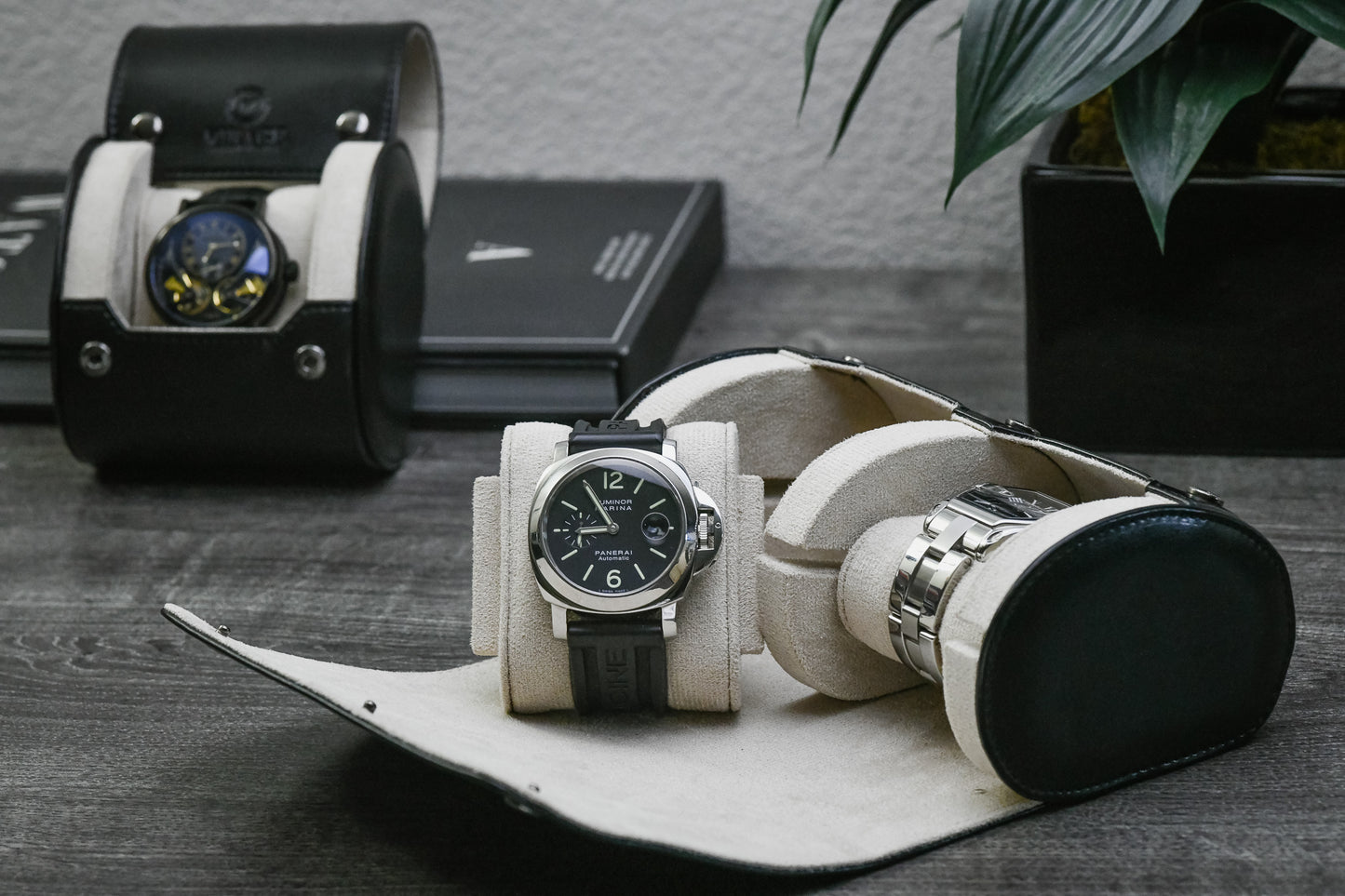 Jade Black vegan leather 2 watch travel case displayed with luxury watches on a premium desk setup.