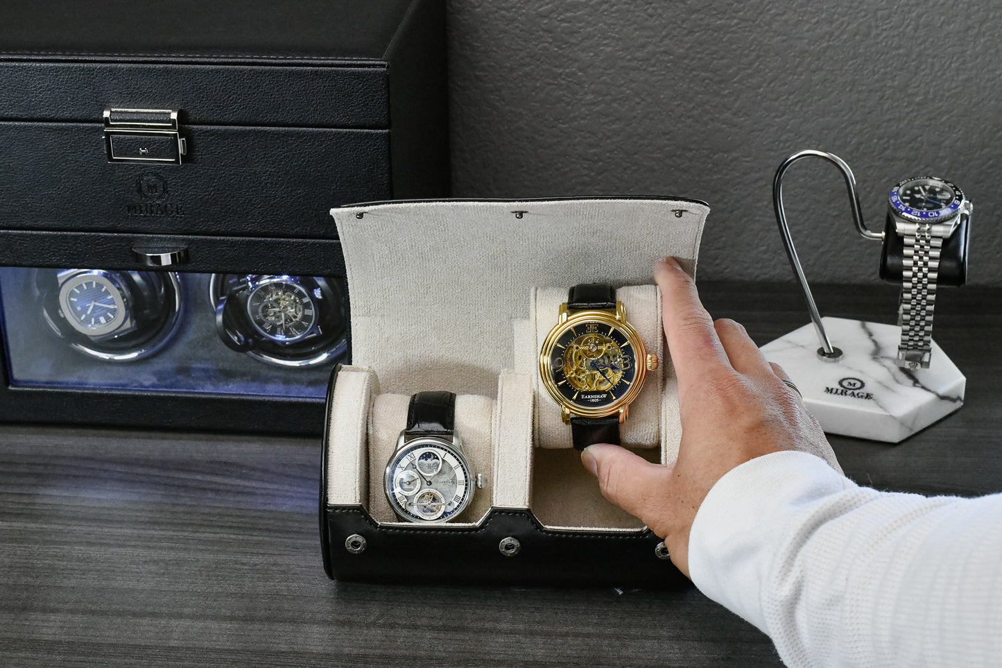 Watch collector placing luxury timepieces inside the Jade Black vegan leather 2 watch travel case.