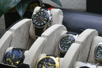 Close-up of luxury watches secured inside Jade Black 6 watch travel case with ivory white suede watch cushions