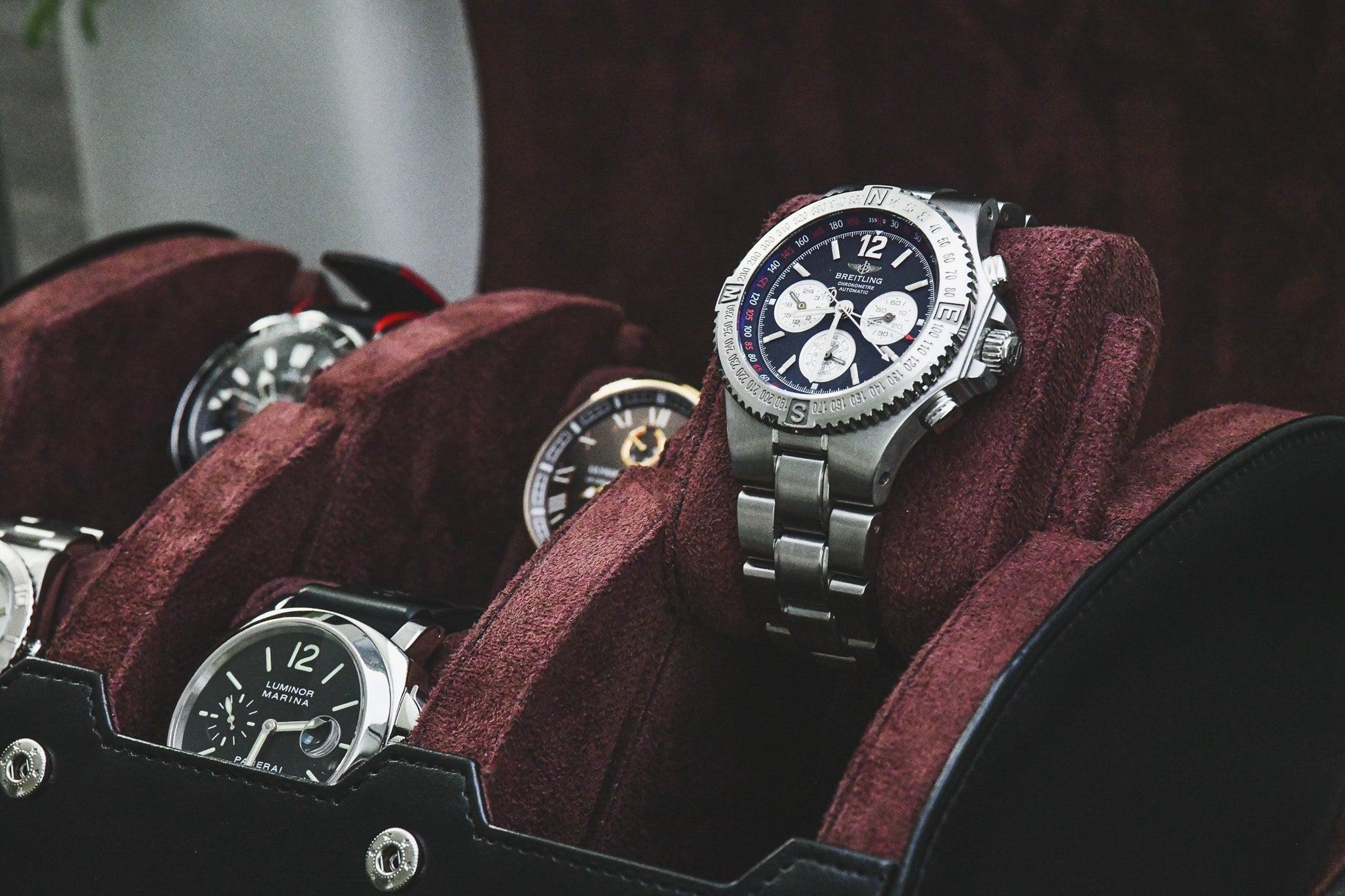 Close-up of luxury watches secured inside the Jade Black suede-lined 6 watch travel organizer