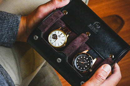 Collector placing luxury watches inside the Jade Black vegan leather 2 watch travel case with protective suede lining.