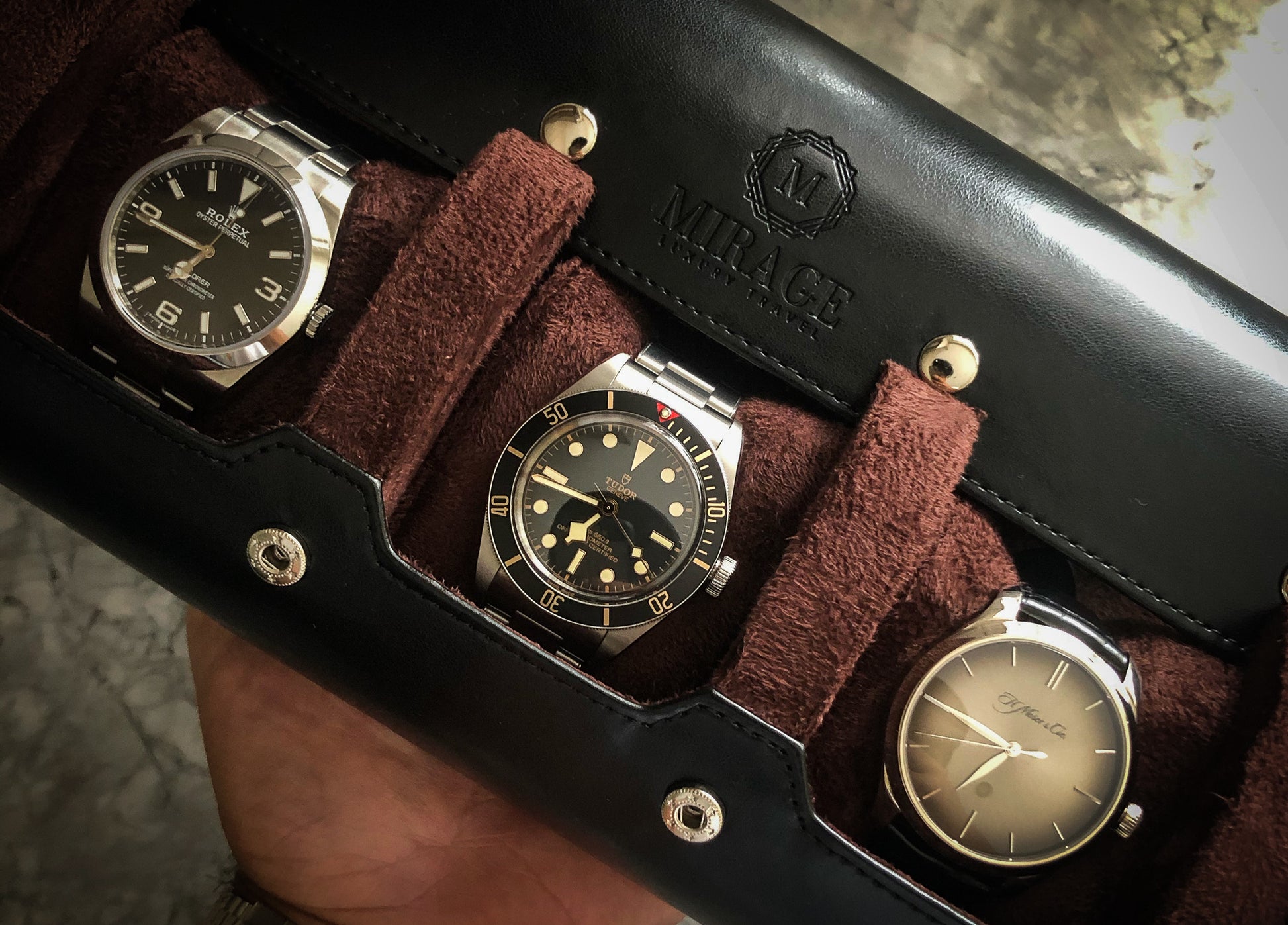 Three luxury watches displayed inside Mirage Jade Black premium vegan leather watch roll organizer