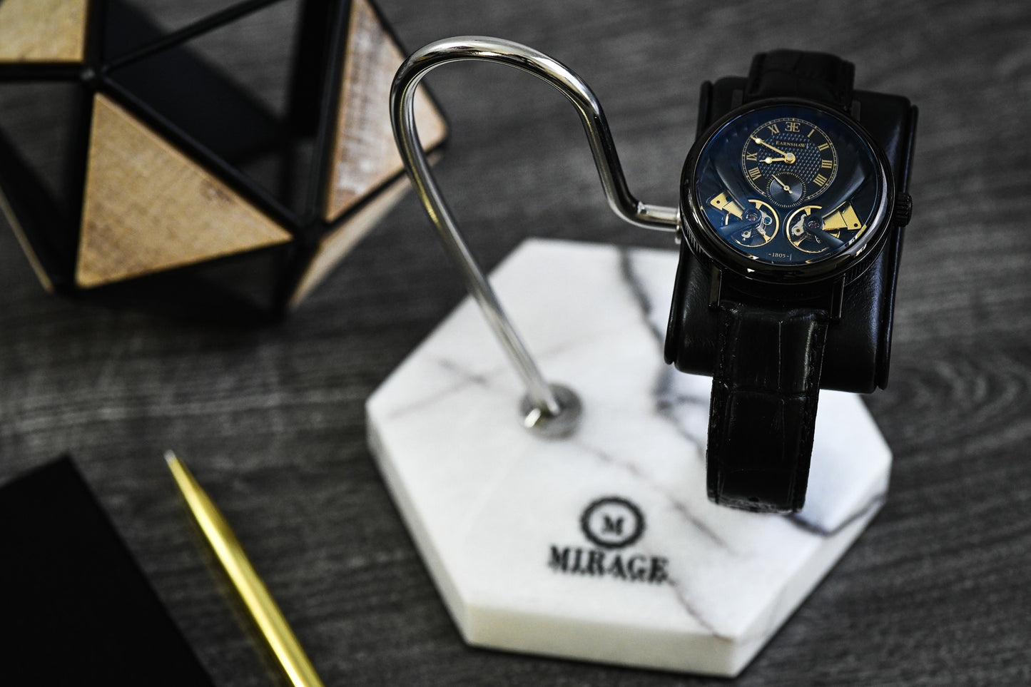 Mirage Luxury Travel Elite White Lilac Marble watch stand displaying a luxury black automatic watch with a genuine black leather cushion and polished stainless steel support.
