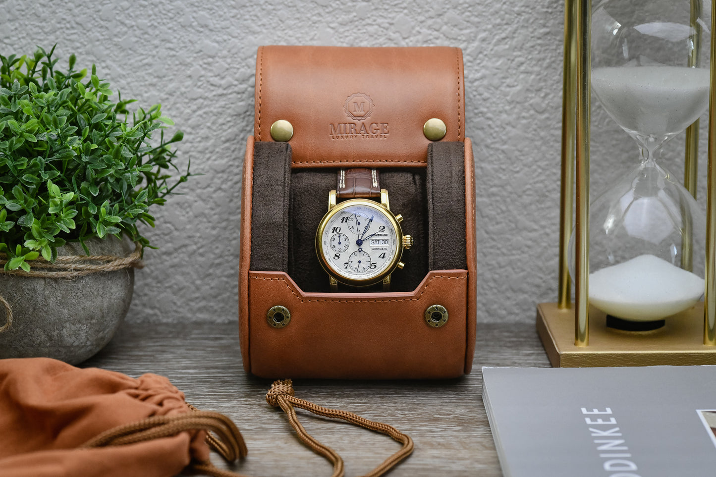 Tawny Brown full-grain cow leather 1 watch roll displayed with a luxury watch, green plant, and elegant home décor for collectors.