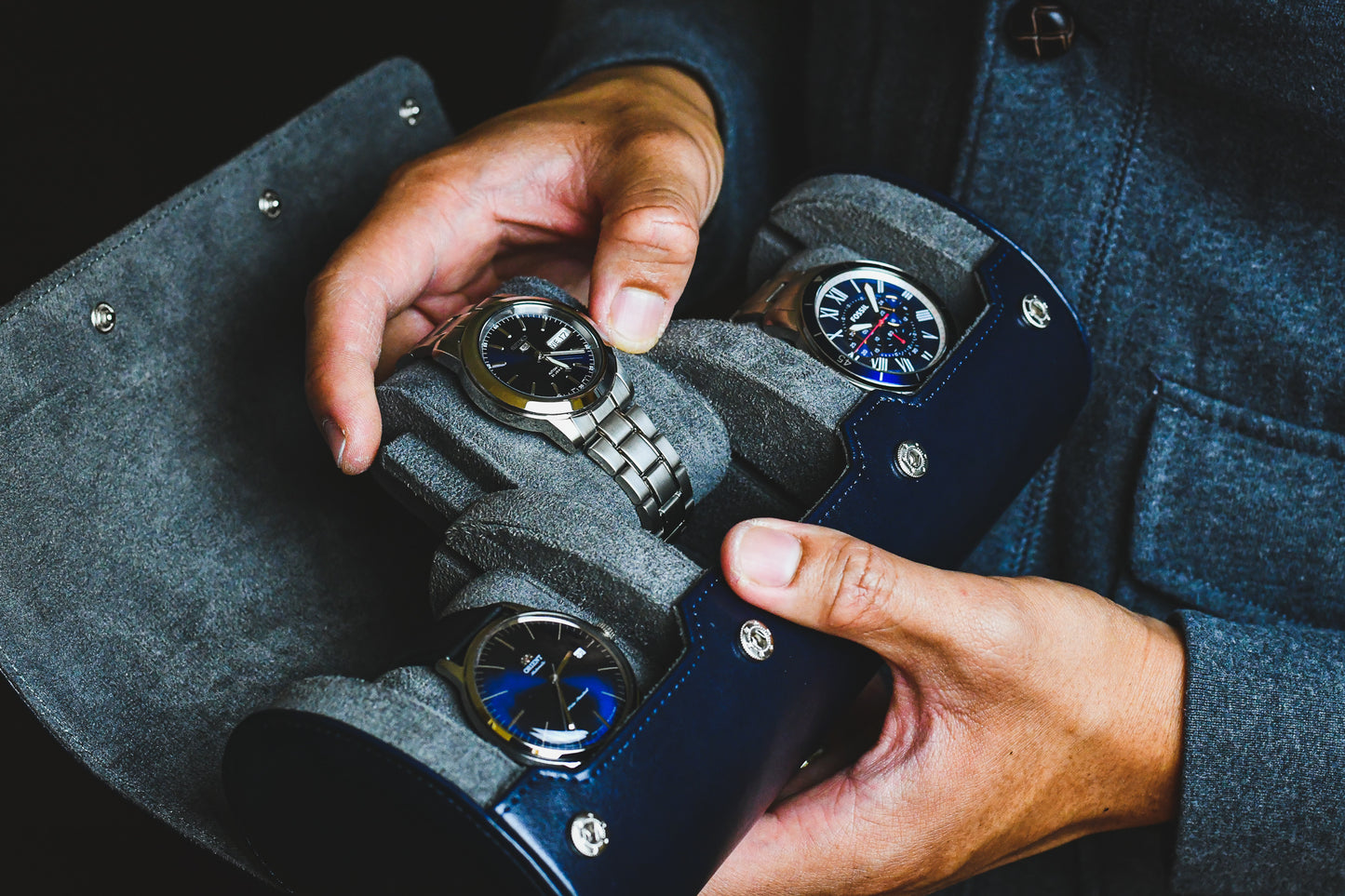 Luxury collector wearing a watch while carrying the Midnight Blue 3 watch travel roll for everyday protection