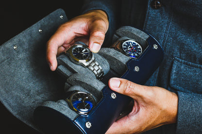 Luxury collector wearing a watch while carrying the Midnight Blue 3 watch travel roll for everyday protection
